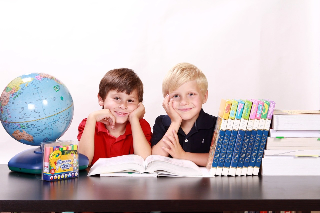 Boys smiling at desk